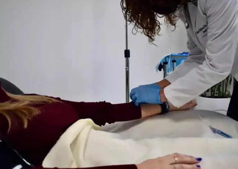 image of a doctor administering ketamine through an IV