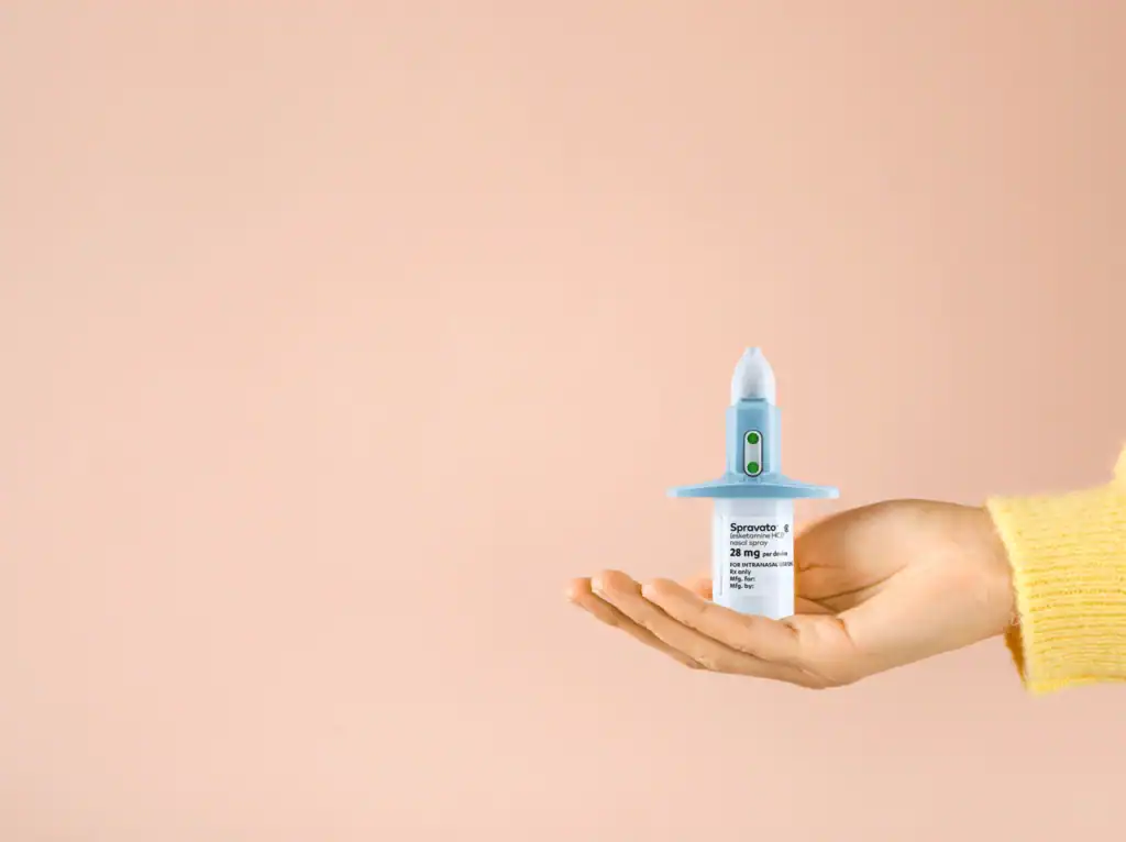 Woman holding Spravato nasal spray